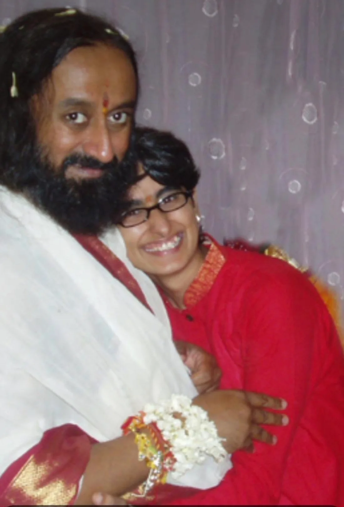 Shreya Chugh smiling as she hugs Gurudev Sri Sri Ravi Shankar