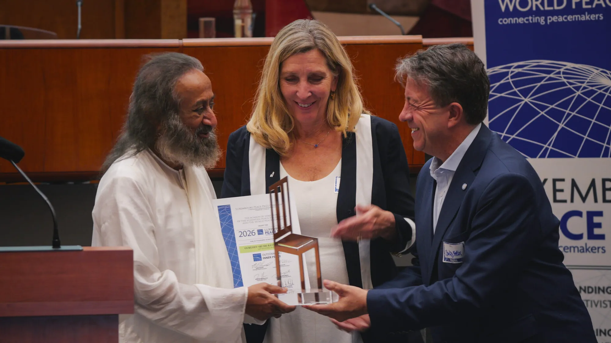 Gurudev receiving a peace award on stage