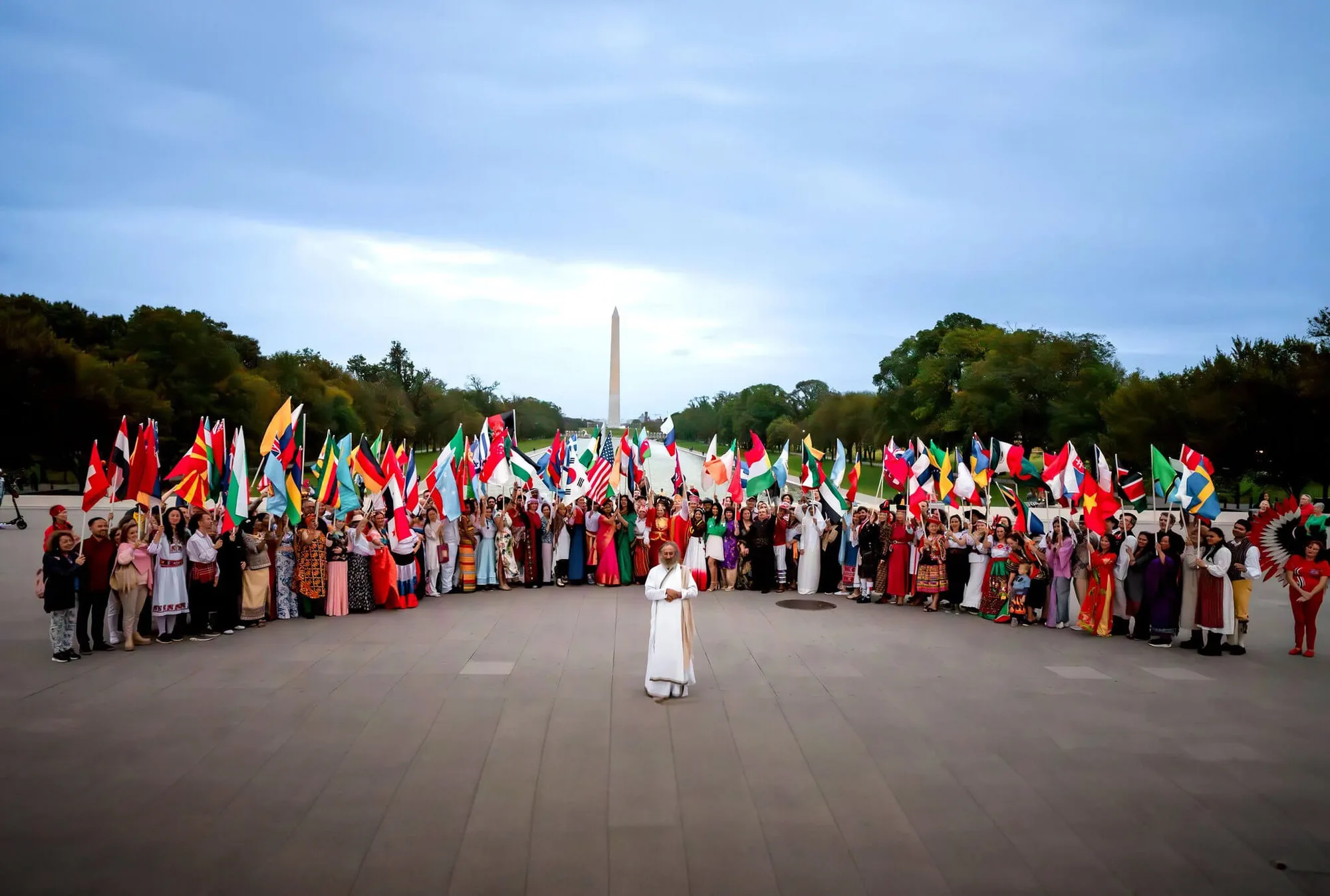 Gurudev at the centre of a large circle of people holding flags of many nations in Washington D.C.
