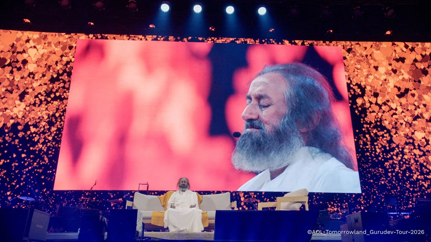 Gurudev leading a meditation on a huge stage screen at Tomorrowland