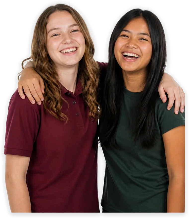 Two teenage friends laughing with their arms around each other