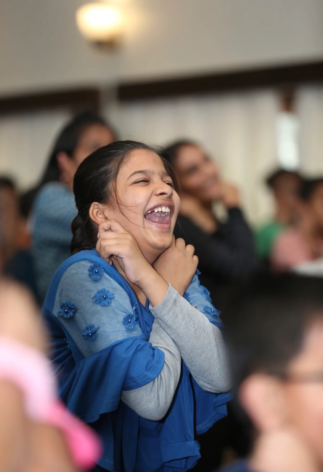 A girl laughing during an Intuition Process session
