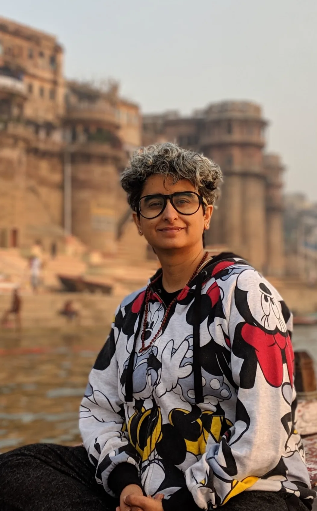 Shreya Chugh on a boat on the Ganga, with the ghats of Varanasi behind her